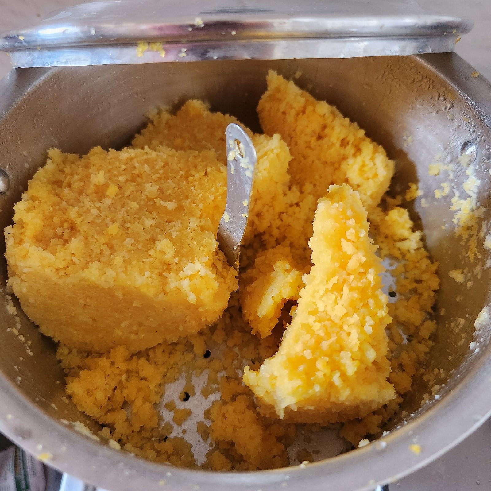Corn cuscuz steamed in an aluminium cuscuzeira