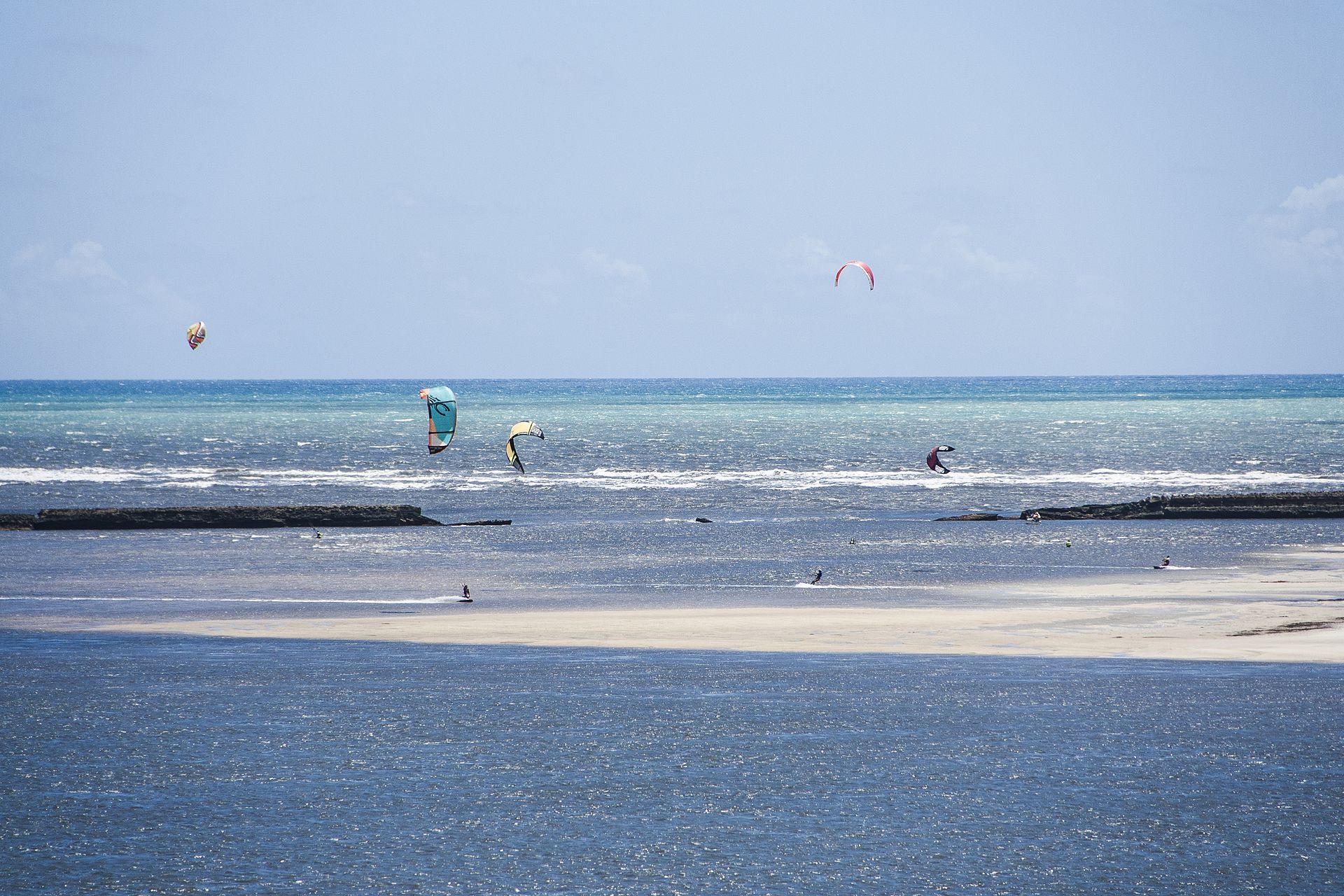 Kitesurf kites over the shallow water at Barra do Cunhaú